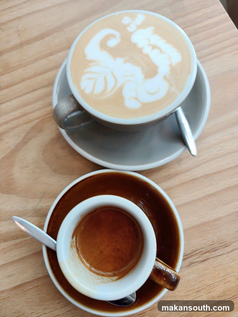 Two coffee drinks on a wooden table