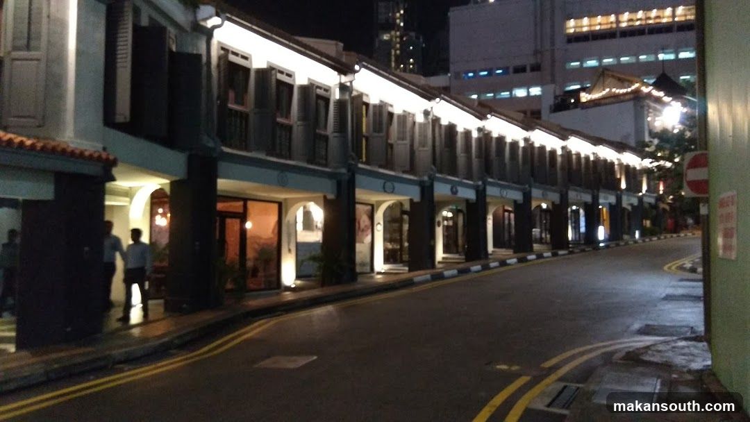 Row of illuminated shops at night