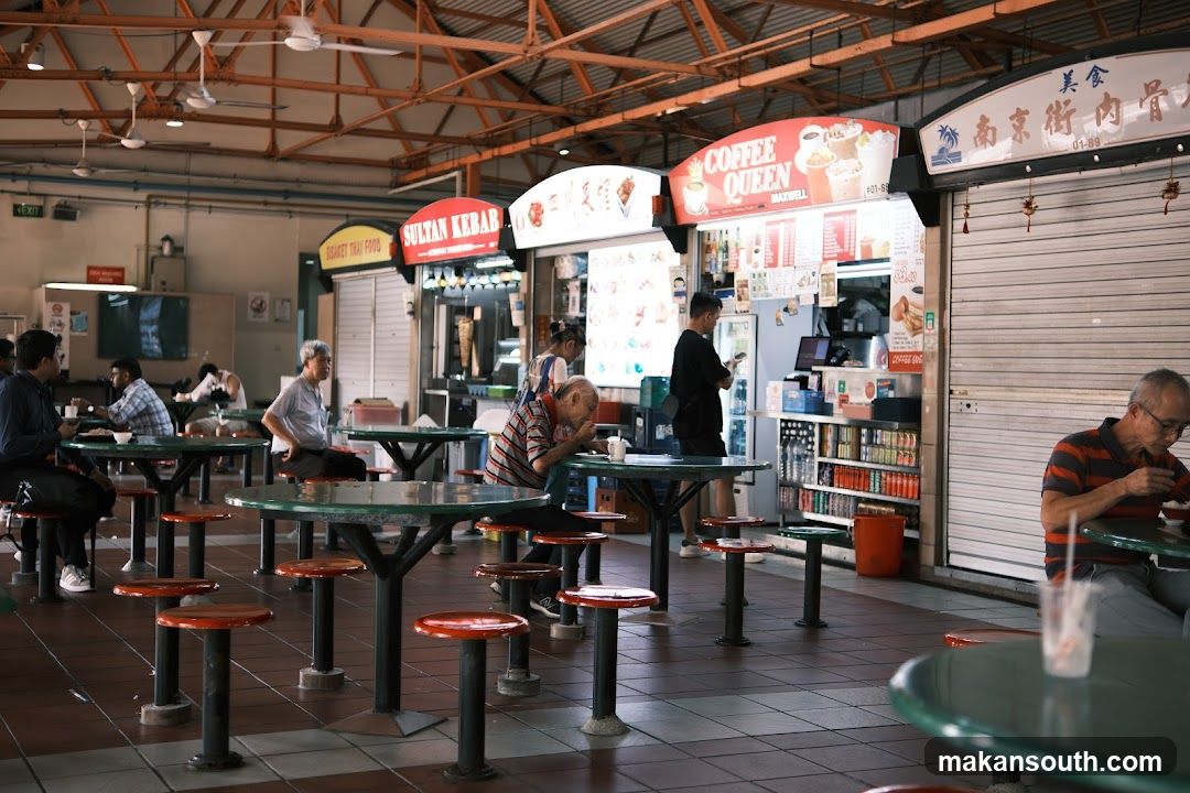 Food court with various stalls and patrons