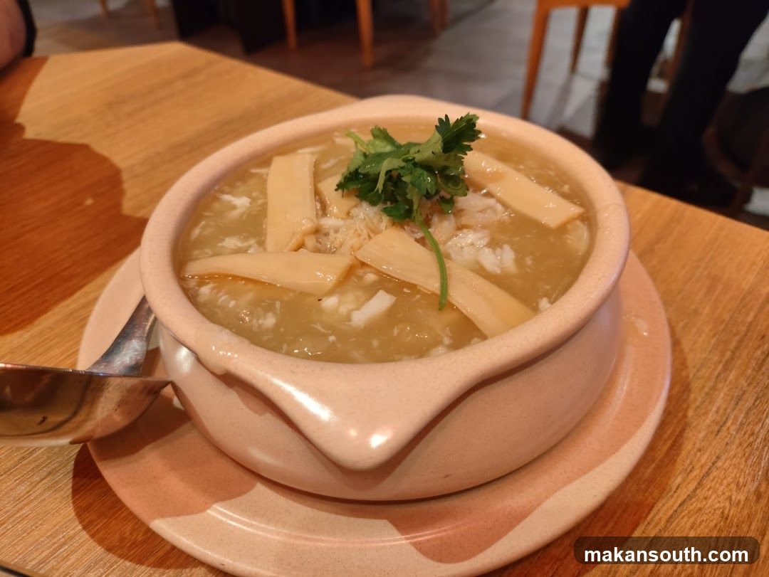 Bowl of soup with bamboo shoots and cilantro