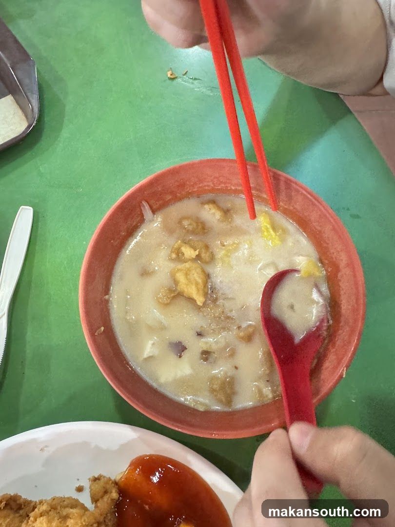Bowl of Porridge with Chopsticks and Spoon