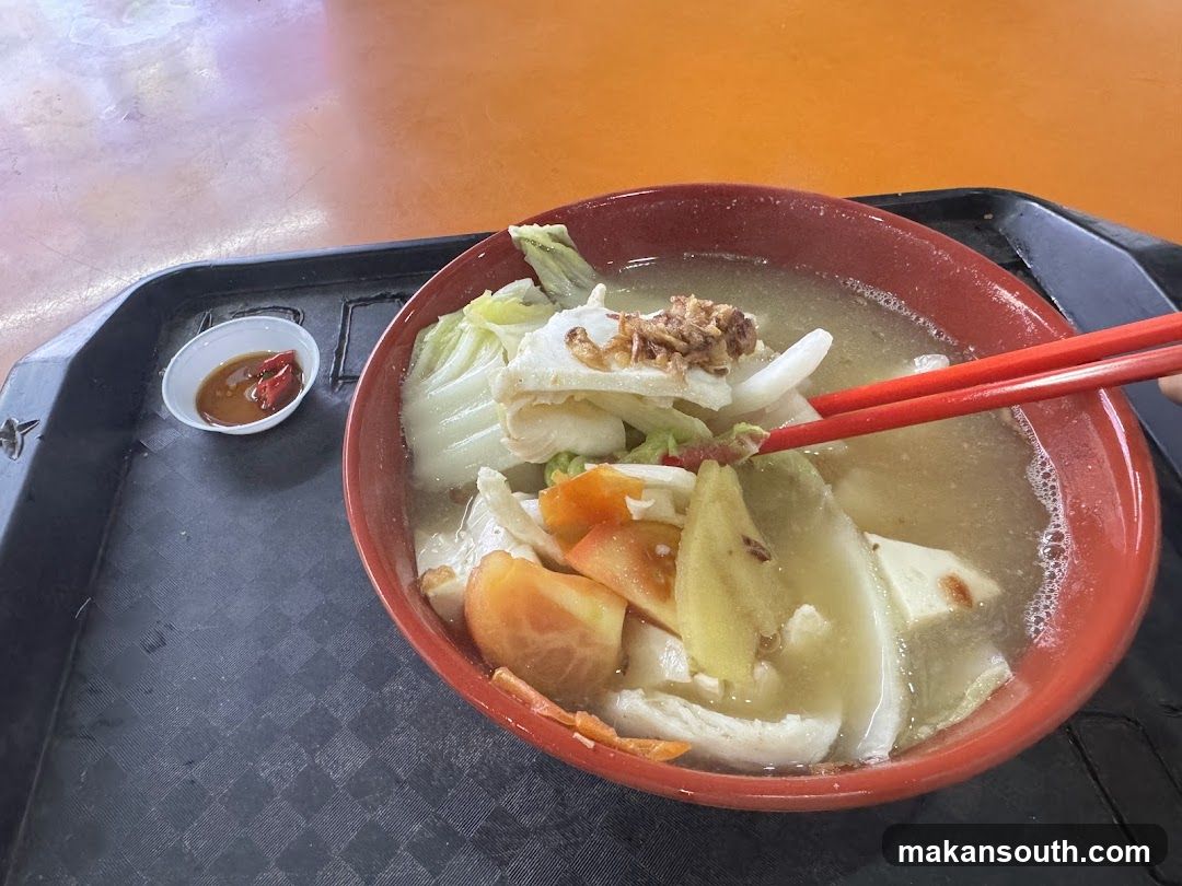 Fish soup with vegetables and chili sauce