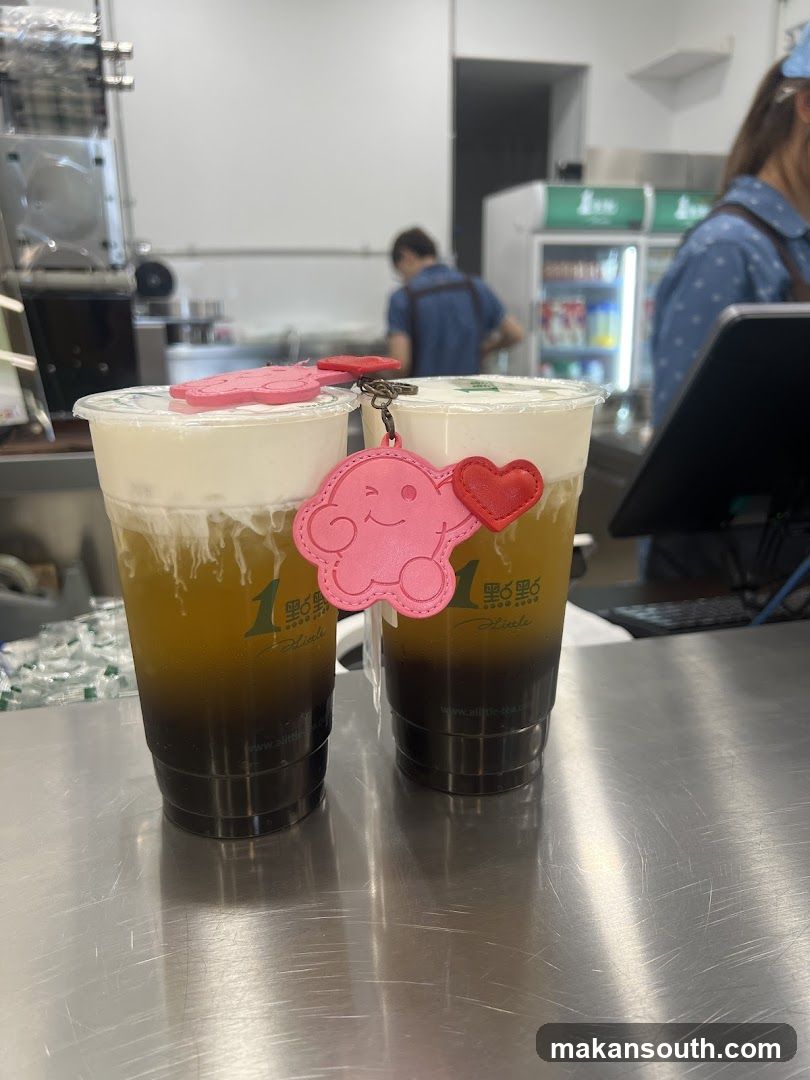 Two bubble tea drinks with cloud charms