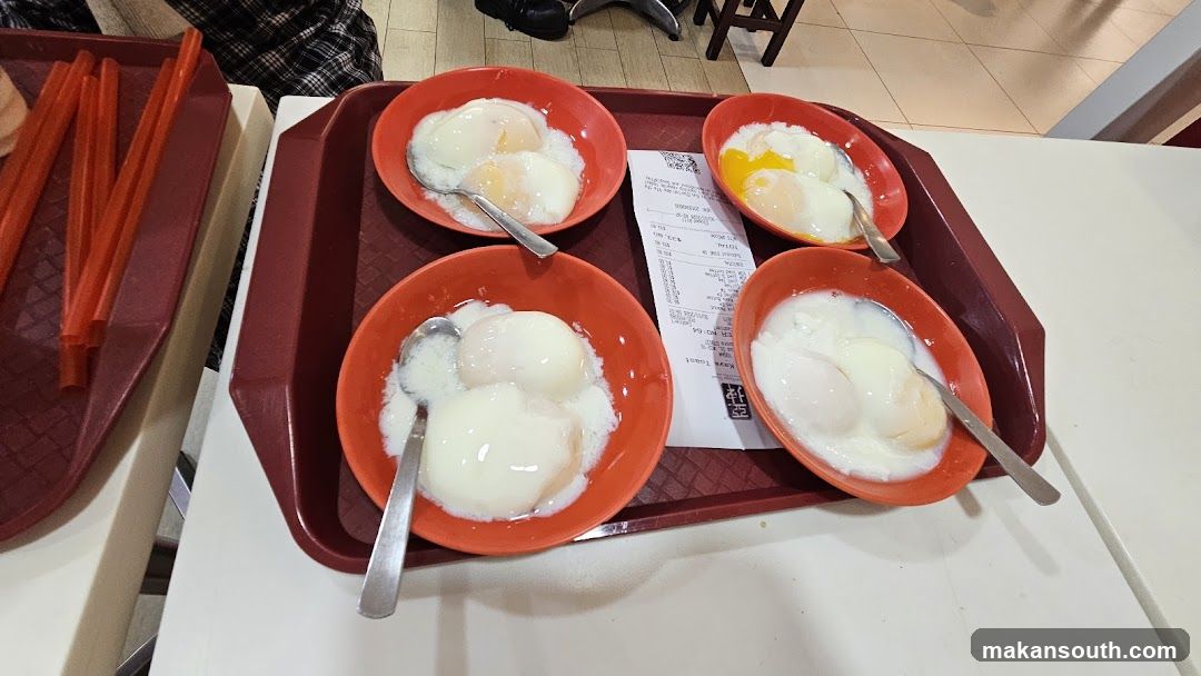 Soft-boiled eggs with spoons on a tray