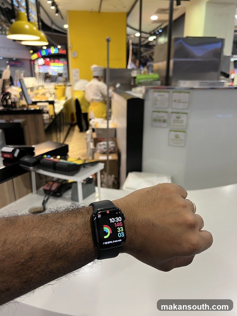 Person wearing a smartwatch in a food establishment