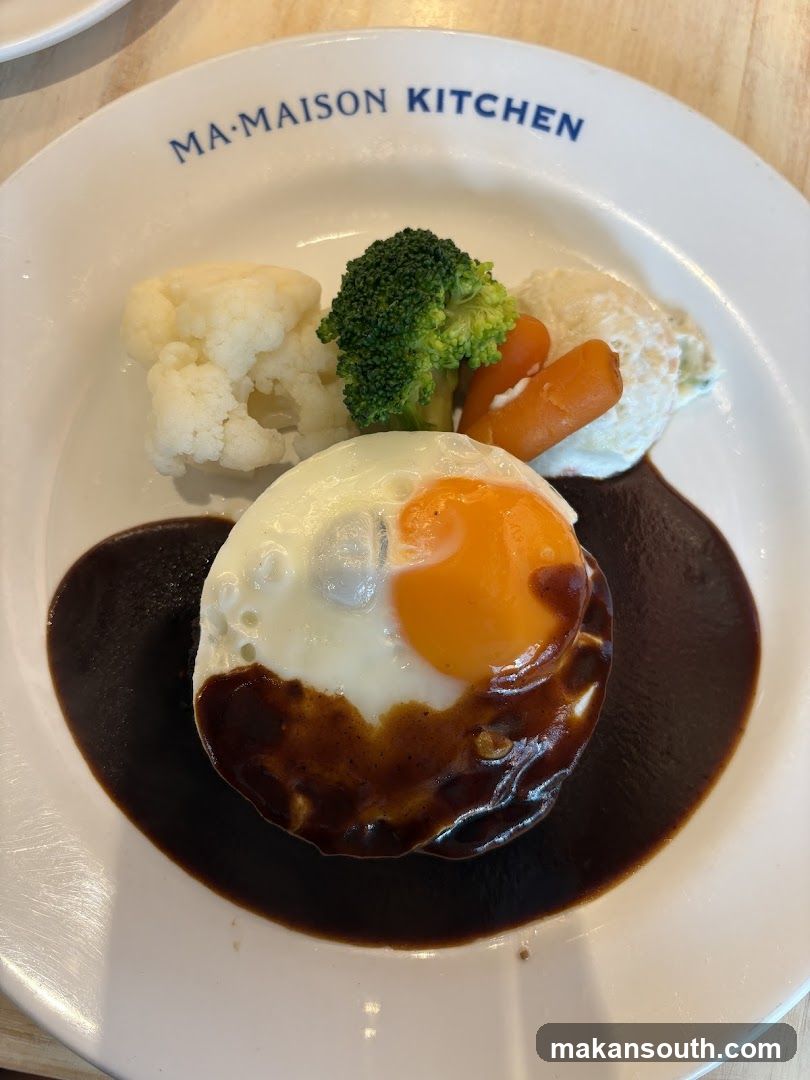 Hamburger steak with fried egg and vegetables
