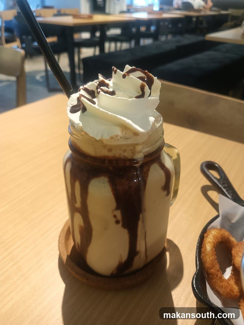 Iced coffee with whipped cream and chocolate drizzle