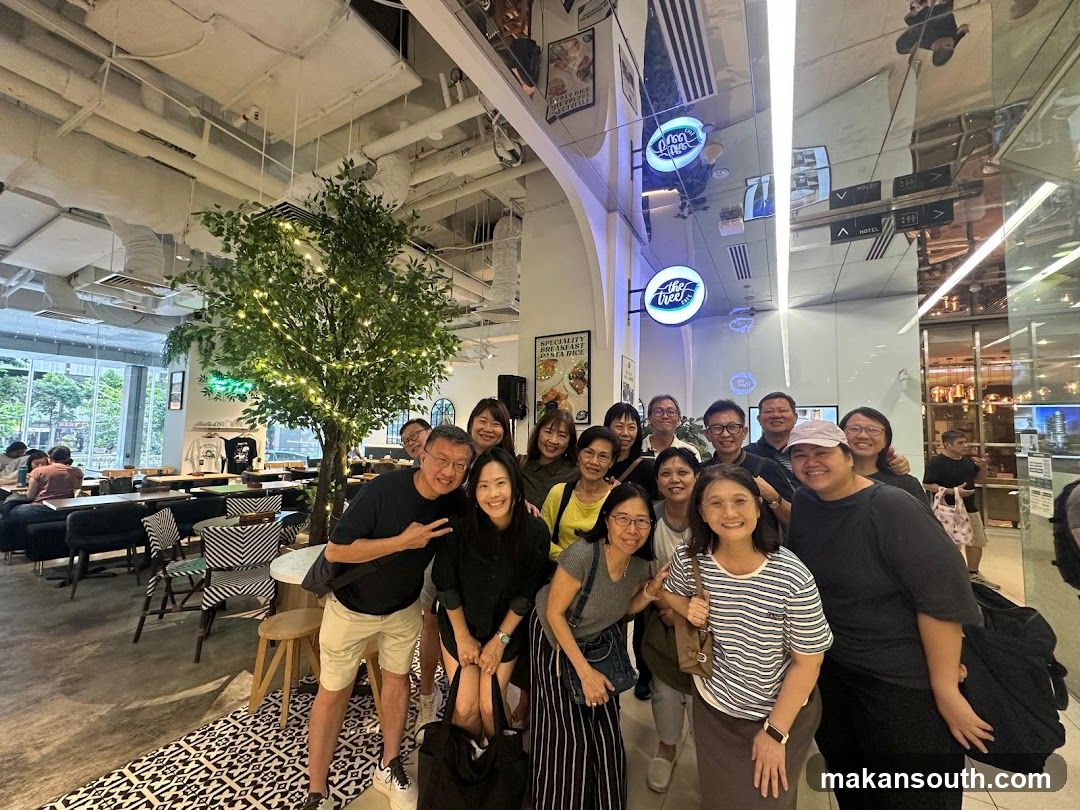 Group of people posing for a photo in a cafe