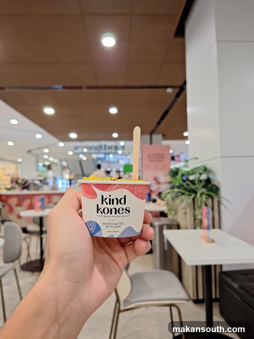 Hand holding a cup of plant-based frozen dessert