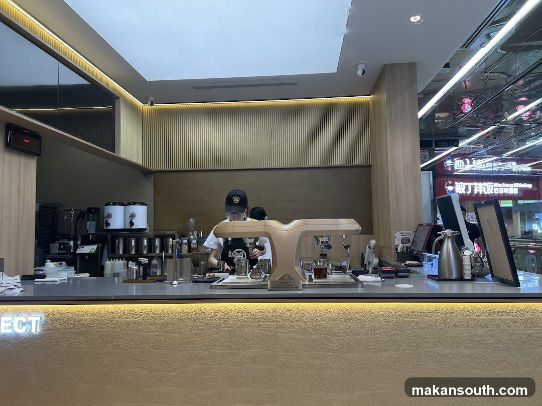 Barista preparing drinks at a coffee counter