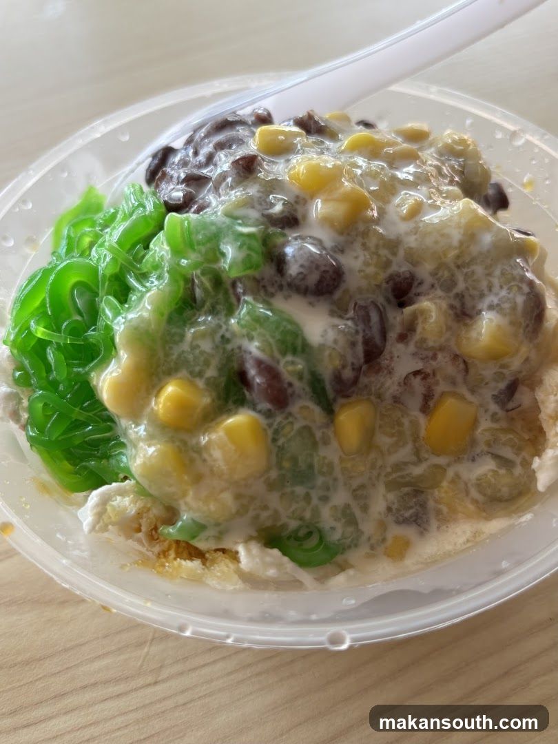Dessert with shaved ice, corn, red beans, and green jelly
