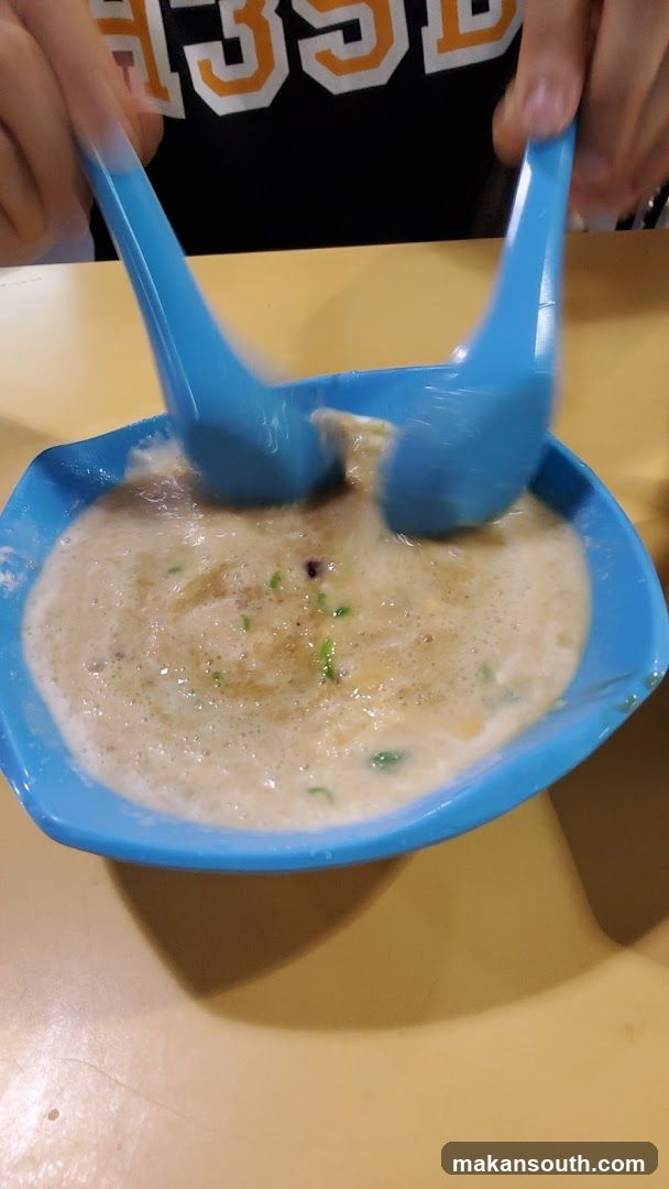 Dessert being mixed with spoons