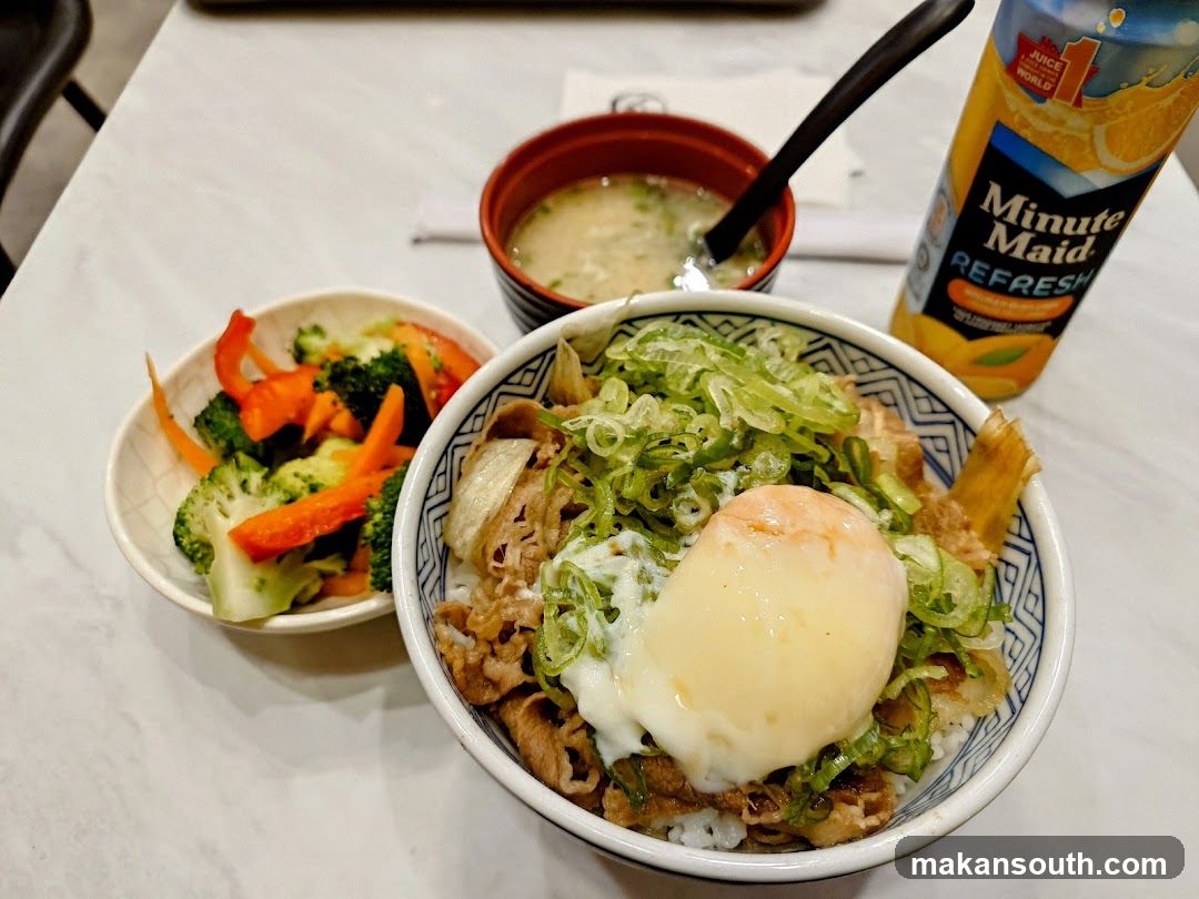 Beef bowl with egg and side salad