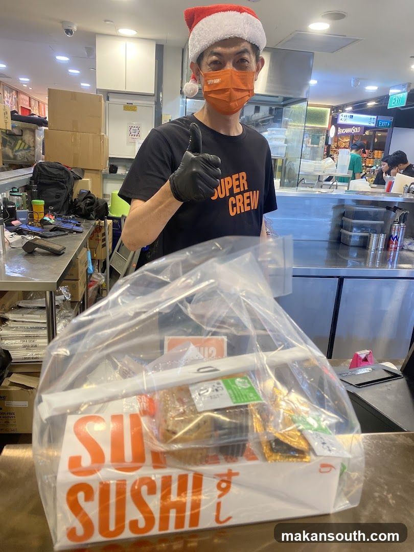 Man in Santa Hat and Mask Holding Sushi Bag