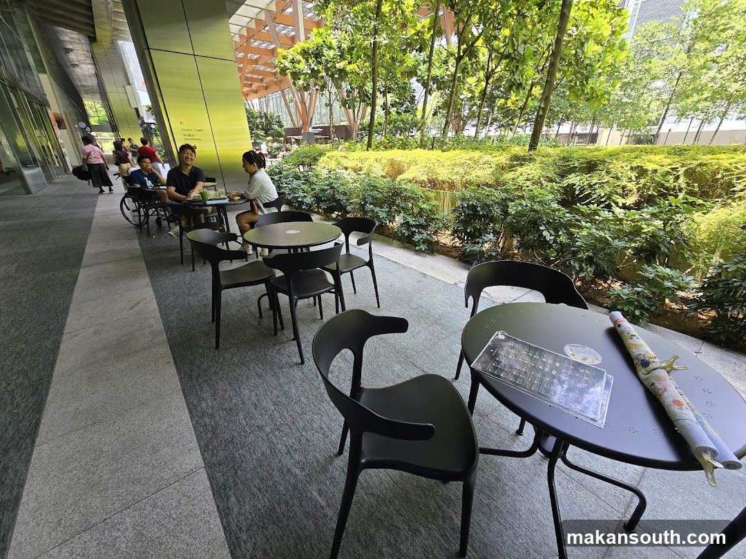 Outdoor cafe seating with greenery