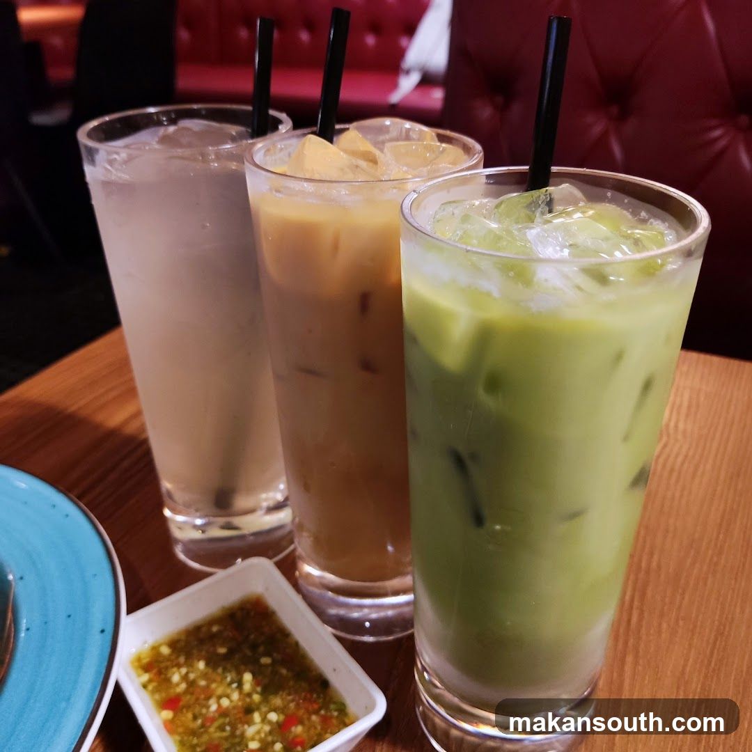 Three iced drinks and a dipping sauce