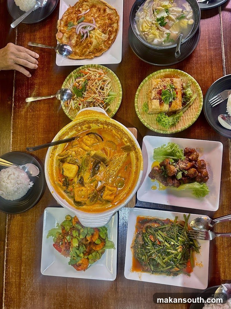 A spread of Asian dishes on a wooden table