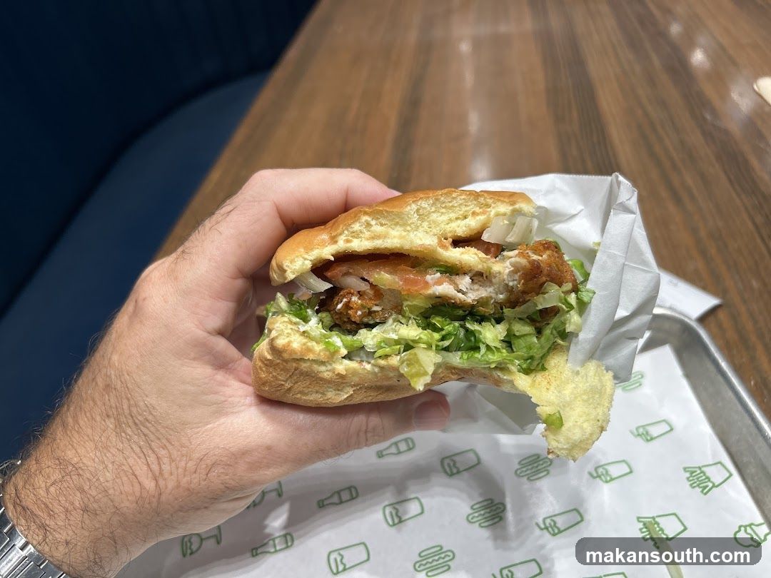 Hand holding a chicken sandwich