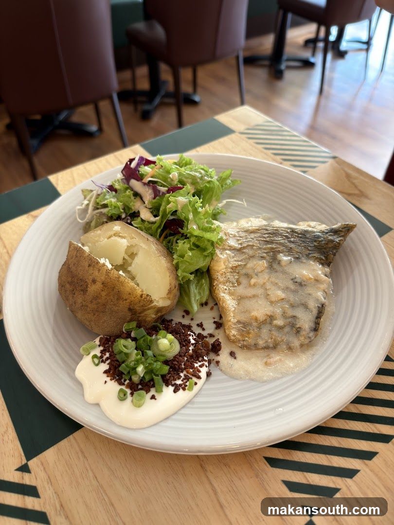 Fish dish with baked potato and salad