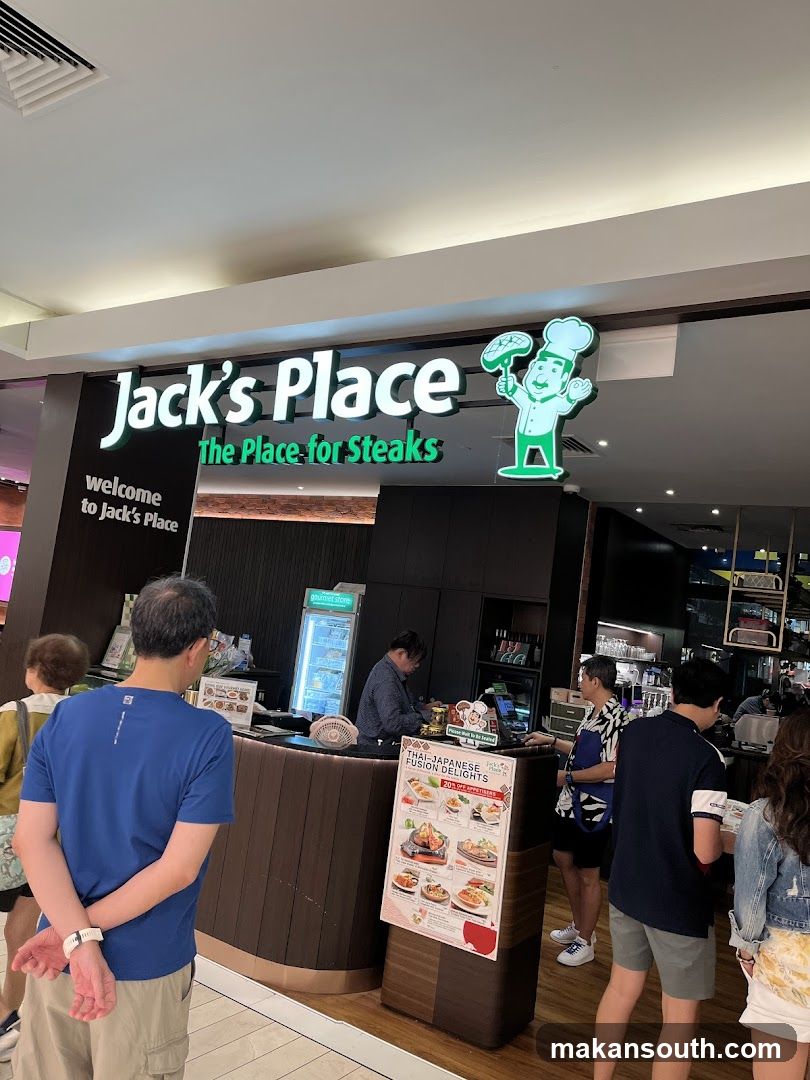 The exterior of a Jack's Place restaurant with its prominent signage and a chef mascot. People are seen queuing at the counter, and a promotional flyer for "Thai-Japanese Fusion Delights" is displayed.