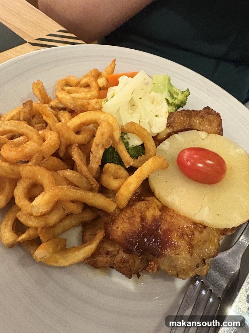 Chicken with curly fries and vegetables