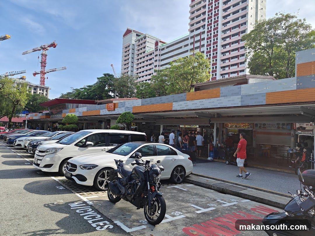 Street scene with parked cars and shops