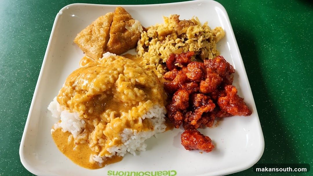 Rice plate with curry chicken, scrambled eggs, and fried tofu