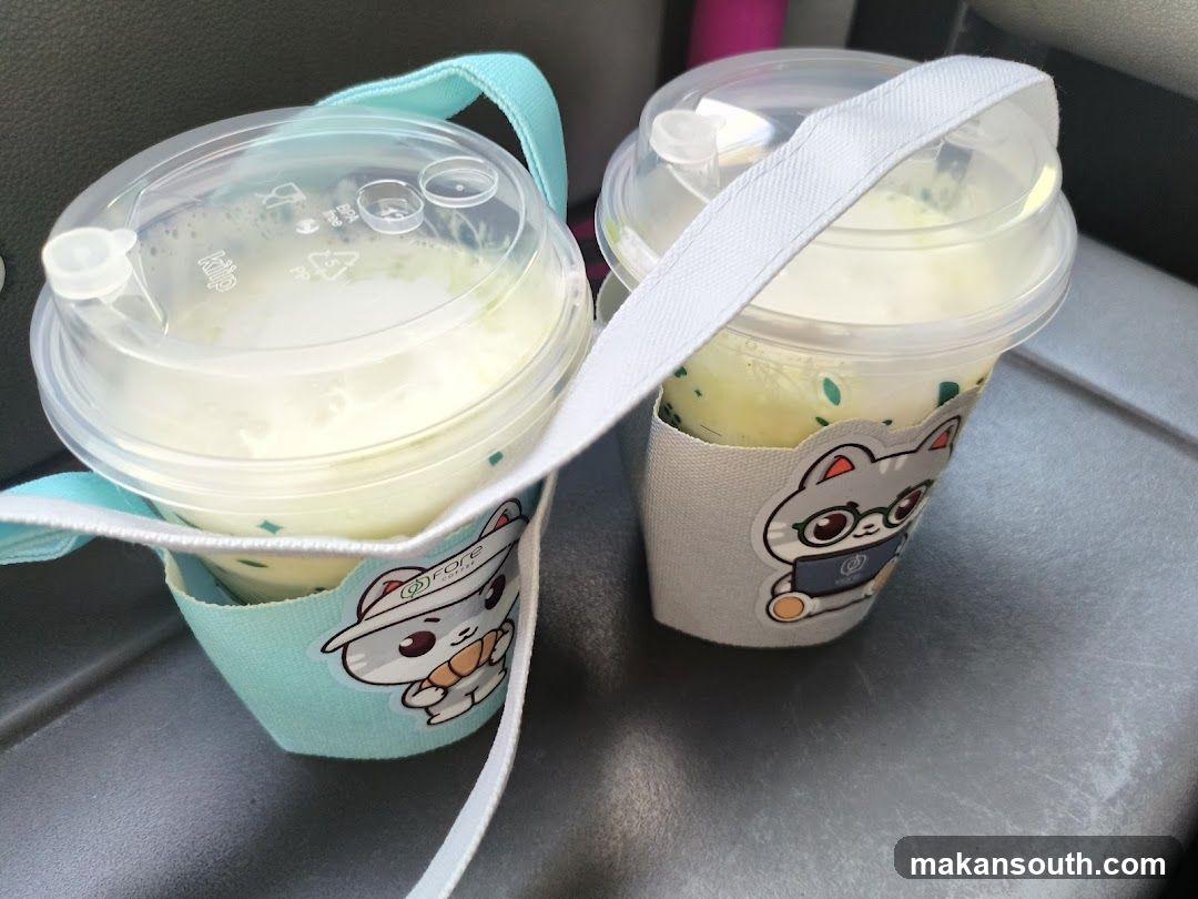 Two drinks in reusable holders