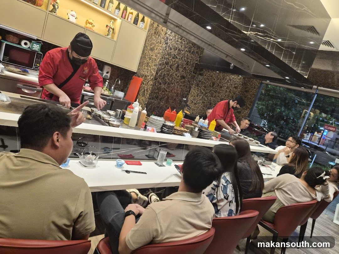 Teppanyaki chefs preparing food for diners