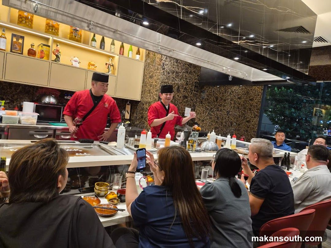 Teppanyaki chefs entertaining diners
