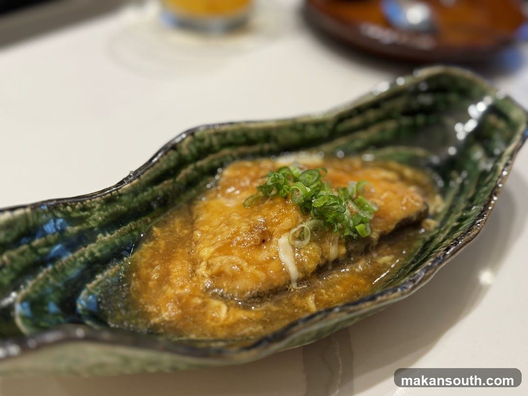 Fish dish with sauce and scallions