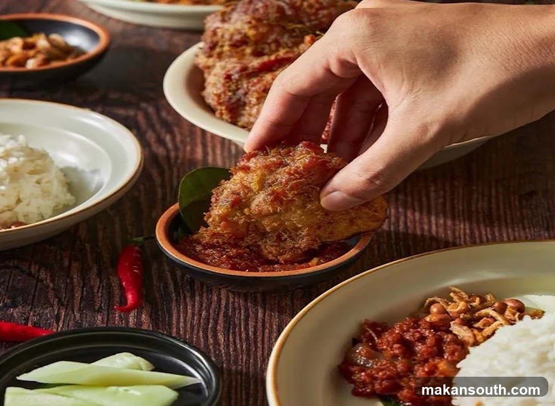 Hand Dipping Fried Food into Sauce