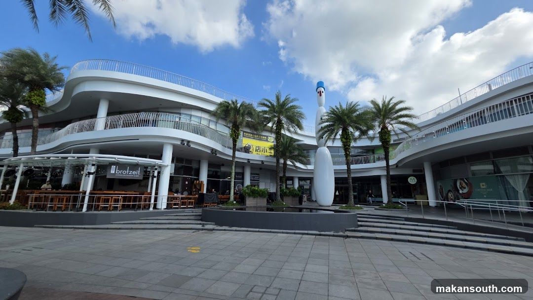 Modern building with outdoor seating and a bowling pin sculpture