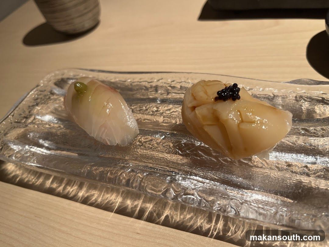 Two pieces of sushi on a glass plate