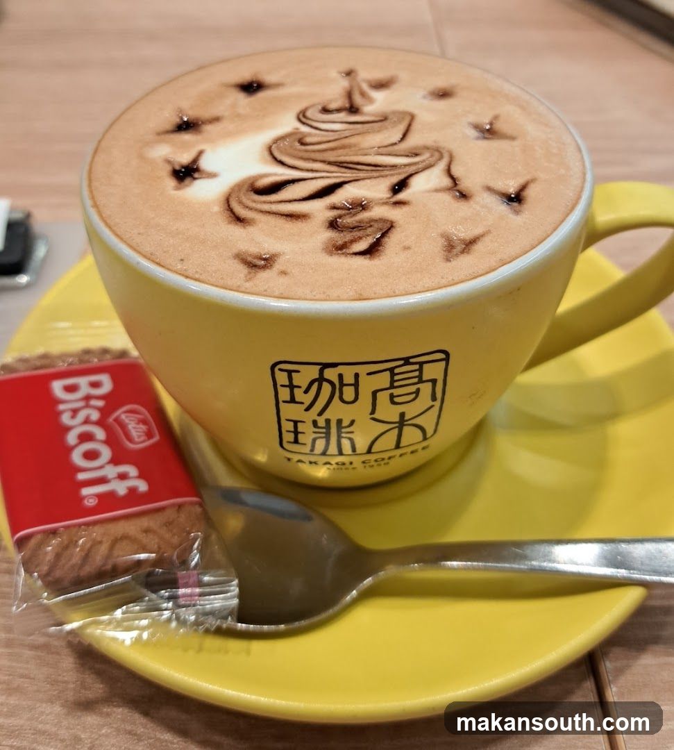Coffee with latte art and biscuit