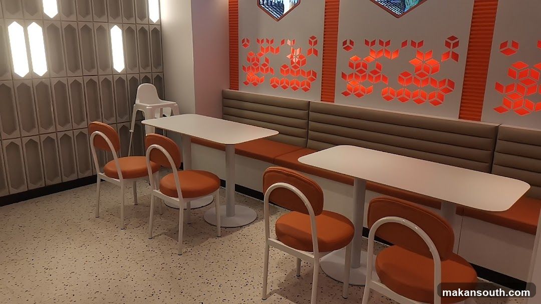 Restaurant Interior with Orange Chairs and White Tables