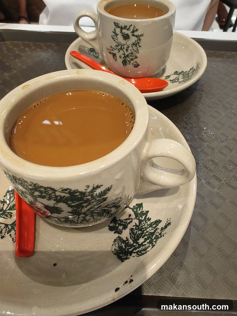 Two cups of coffee with spoons
