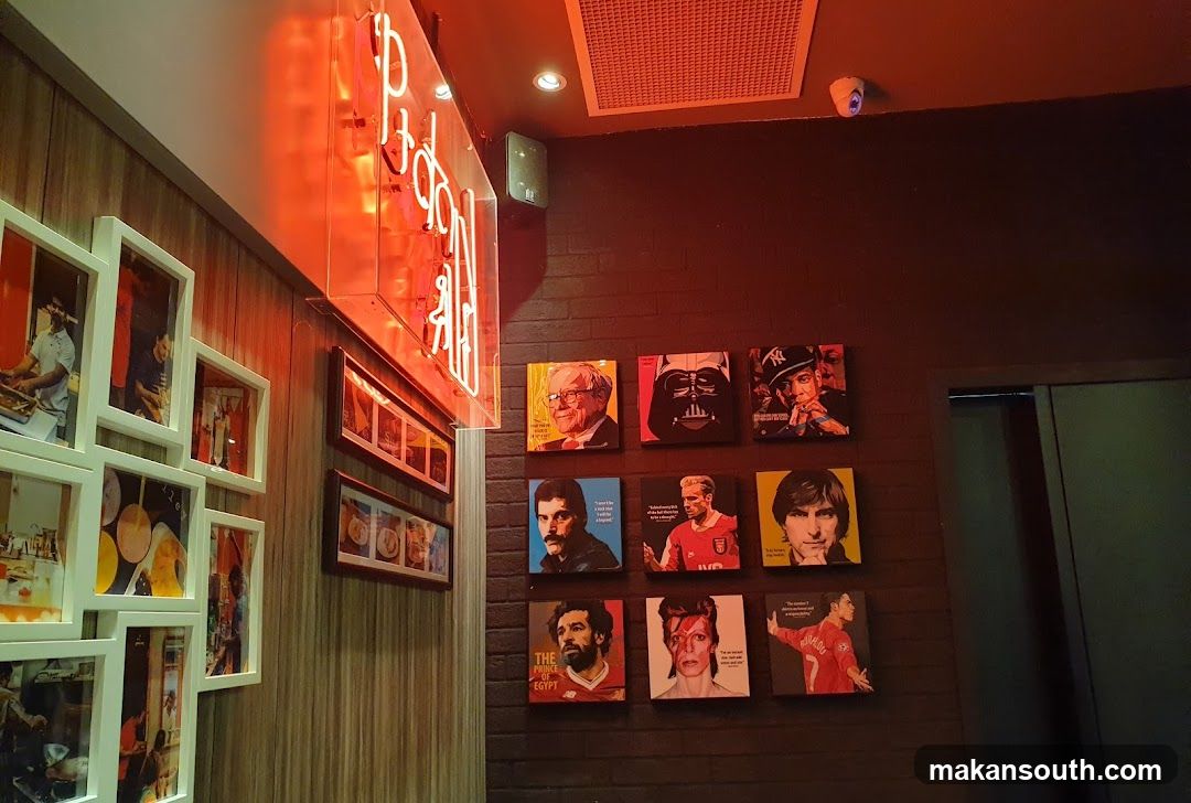 Restaurant Interior with Portraits and Neon Sign