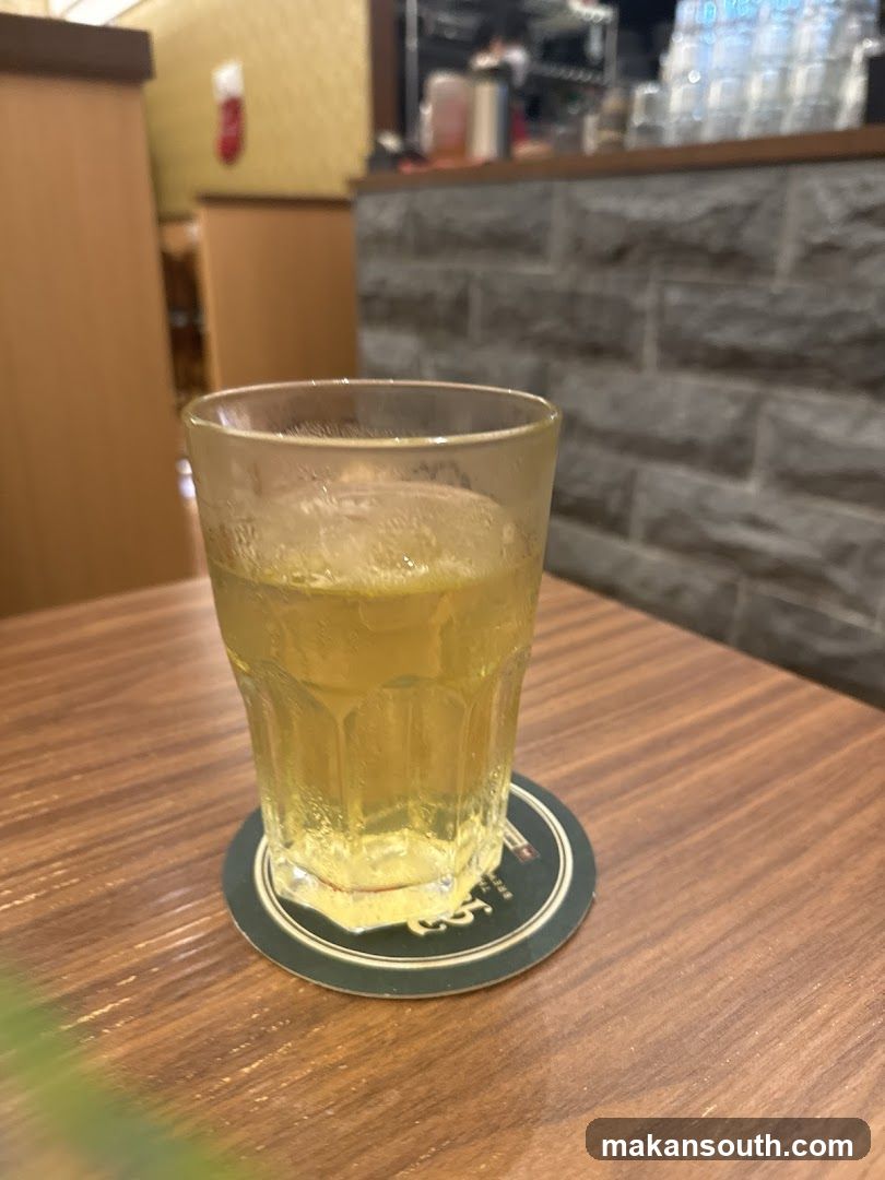 A glass of iced tea on a coaster