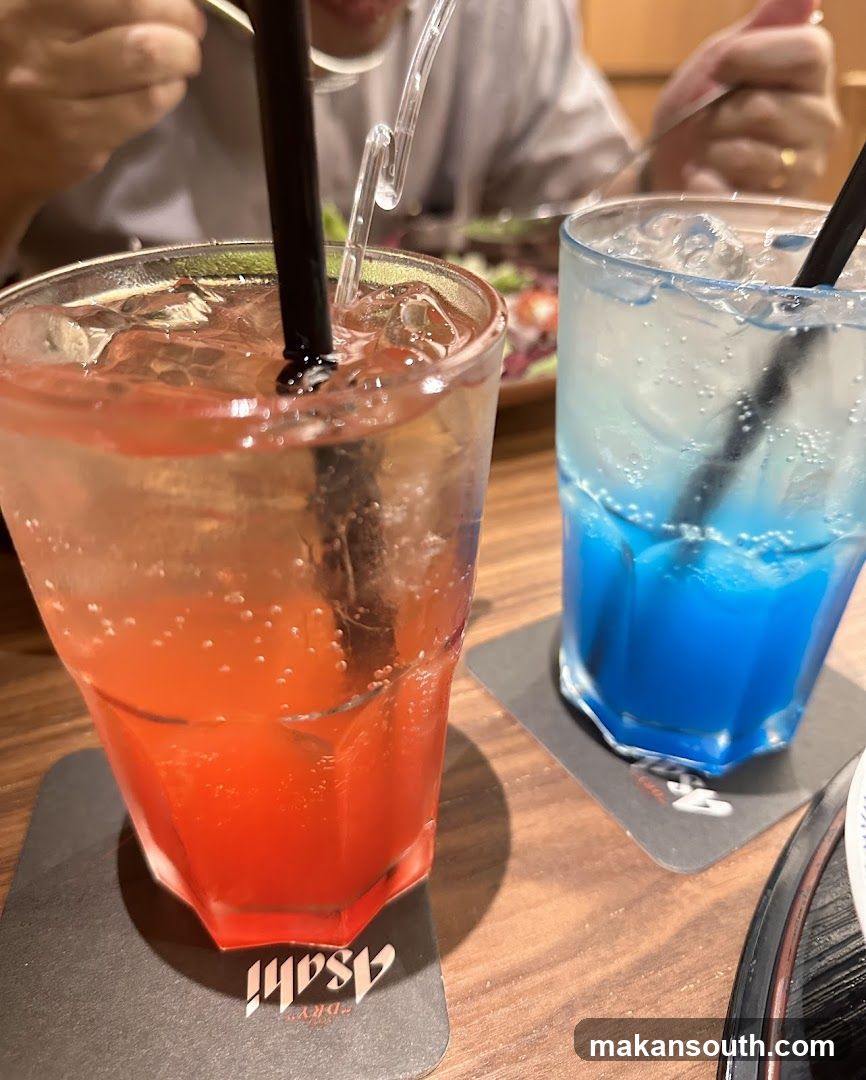 Two colorful drinks on coasters
