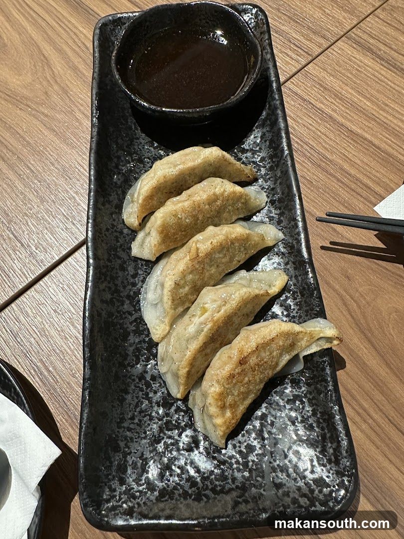 Pan-fried dumplings with dipping sauce