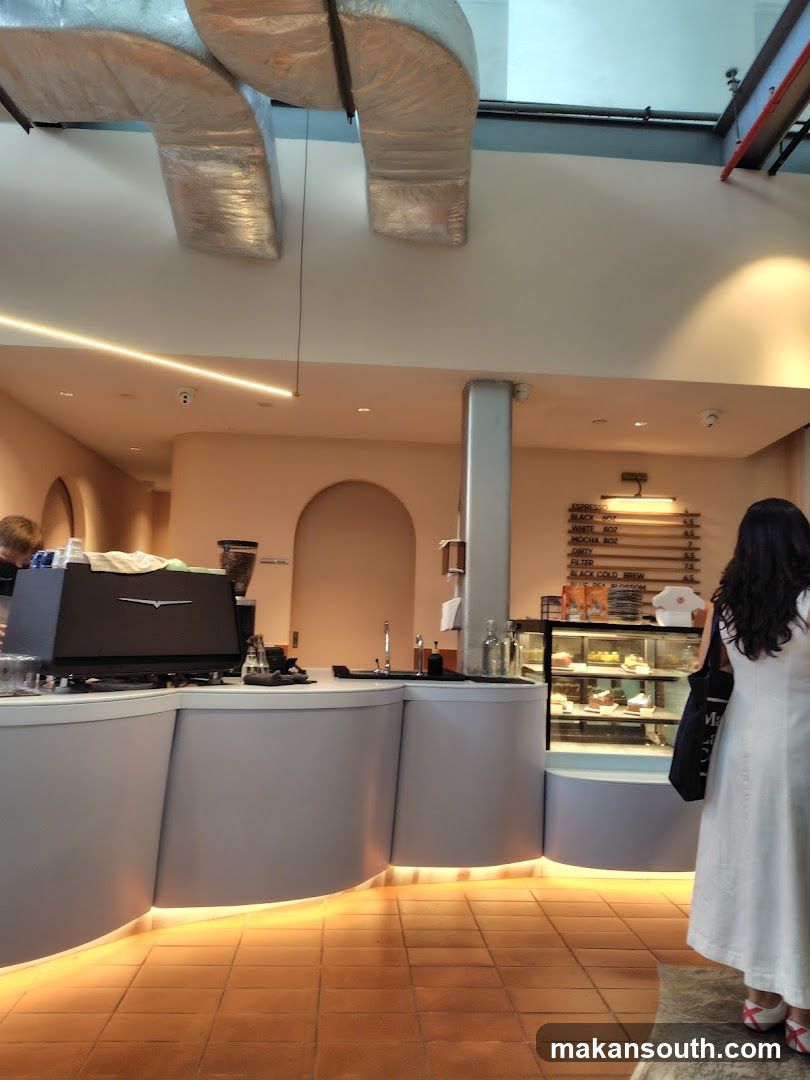 Cafe Interior with Display Cases and Menu