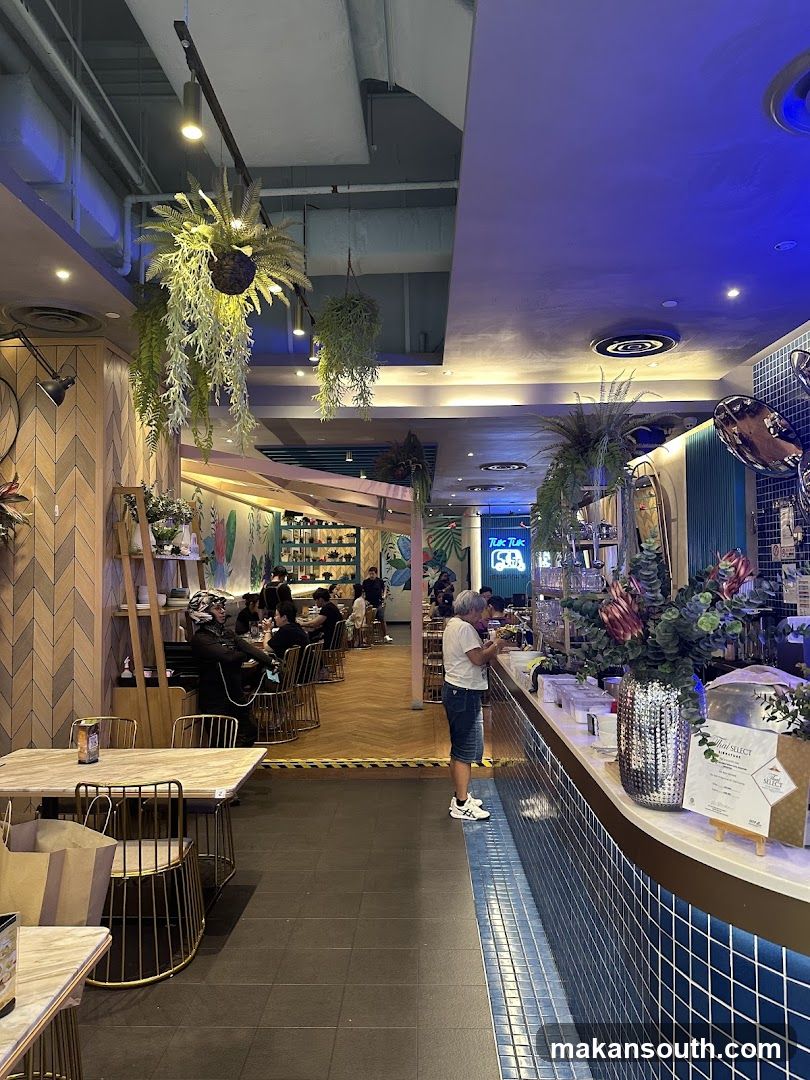 Interior of a restaurant with hanging plants and a counter