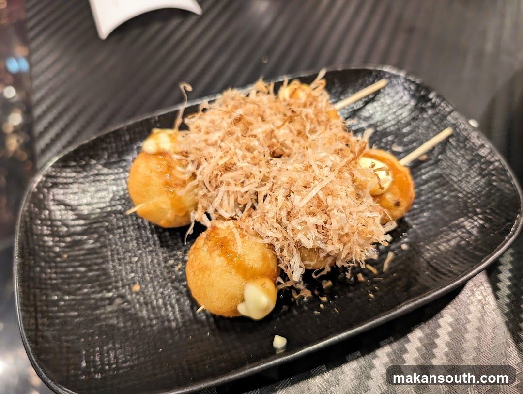 Takoyaki on a black plate