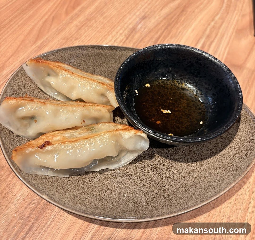 Pan-fried dumplings with dipping sauce