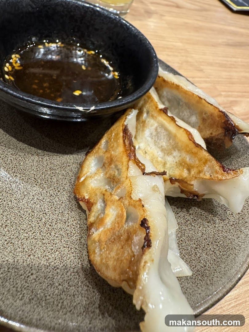 Pan-fried dumplings with dipping sauce