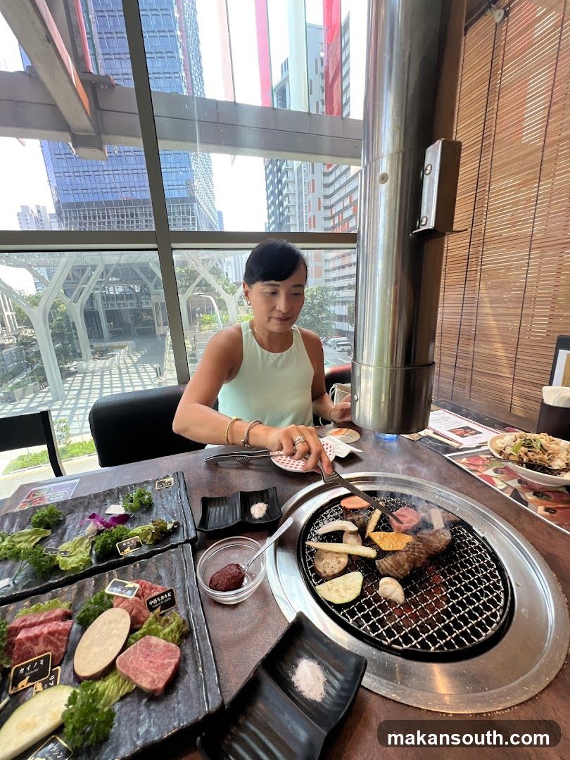 Woman Grilling Meat at a Restaurant