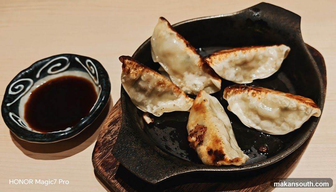 Pan-fried dumplings with dipping sauce