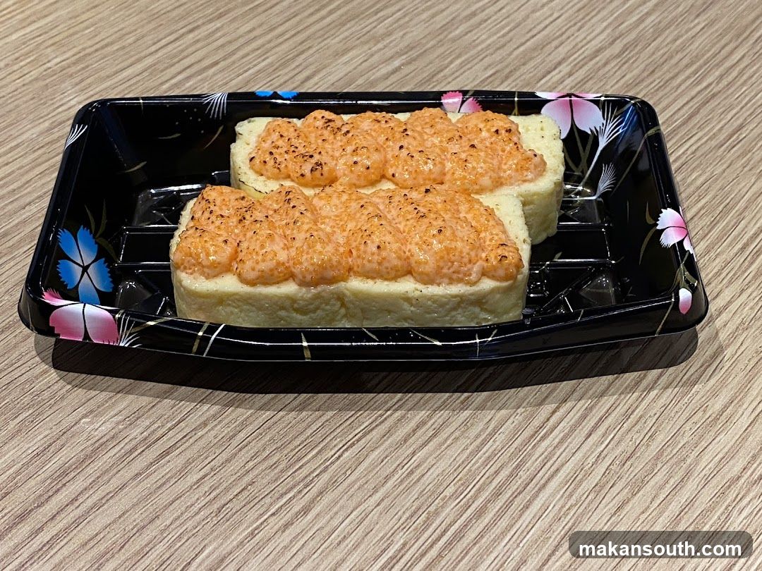 Two pieces of sushi with torched topping