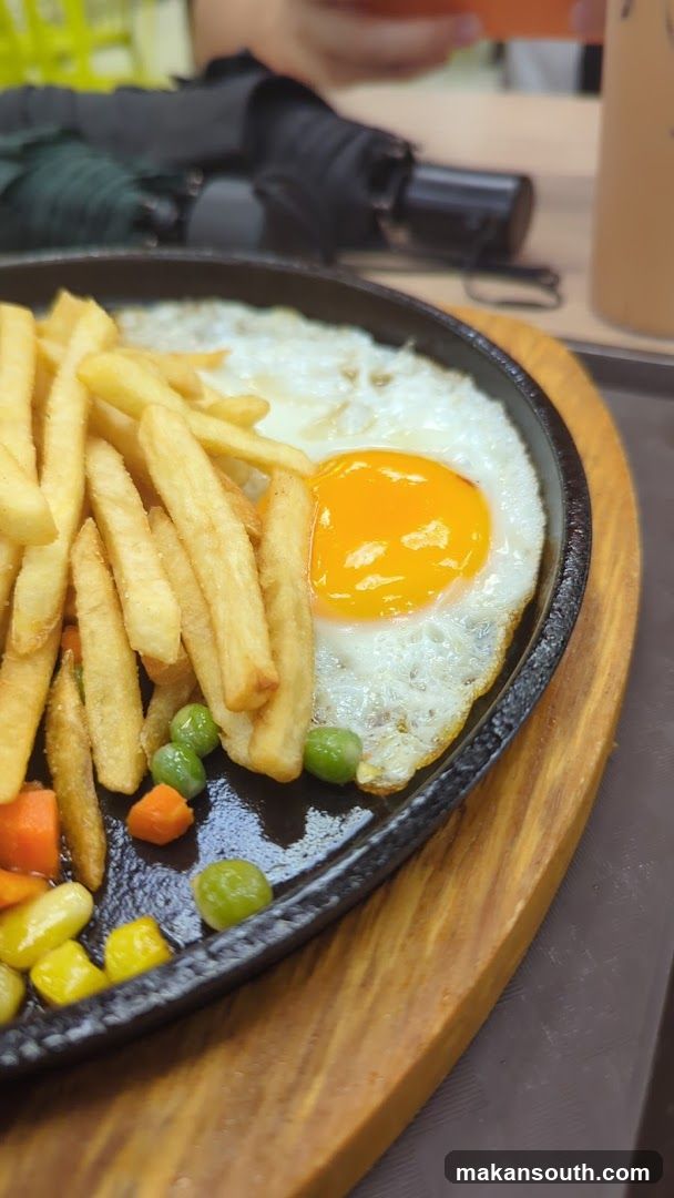 Sizzling Plate with Egg and Fries